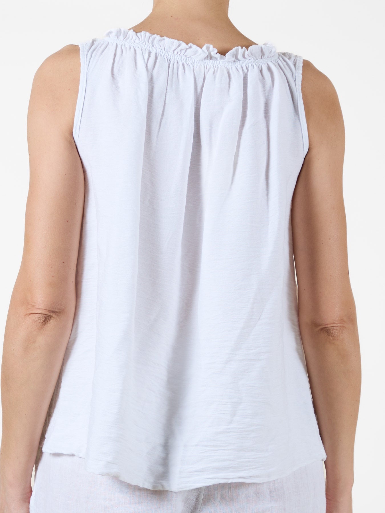 White Sleeveless Top with Ruffled Neckline and Side Tie
