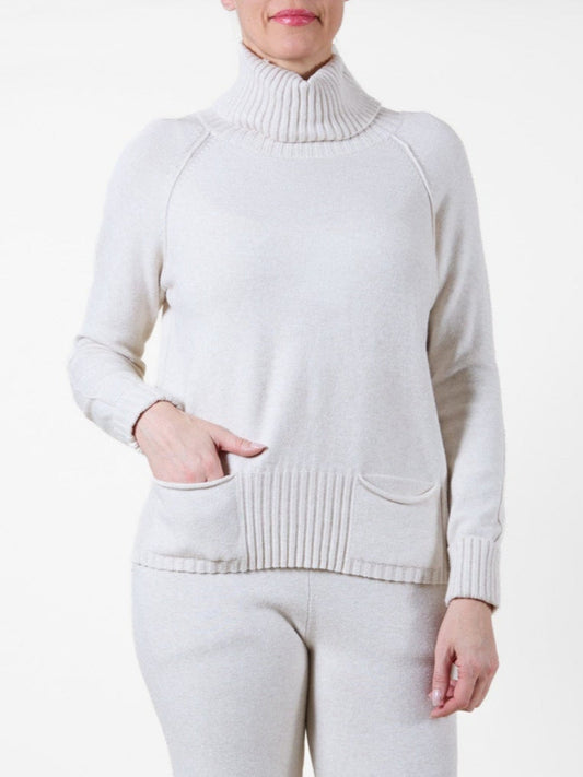 Pull beige à col châle, manches longues, coutures extérieures, 2 poches et finitions côtelées.