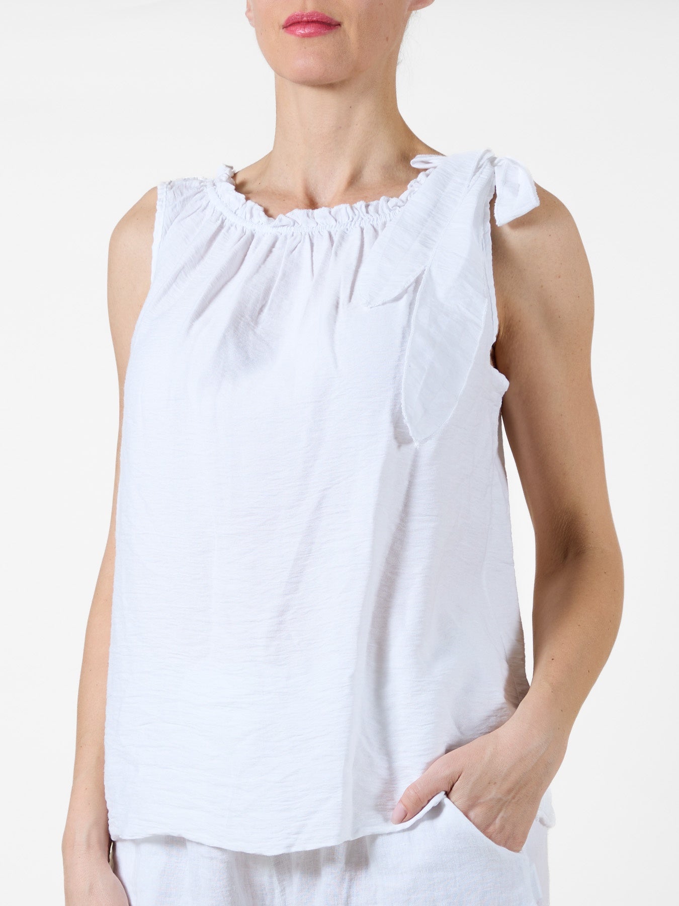 White Sleeveless Top with Ruffled Neckline and Side Tie
