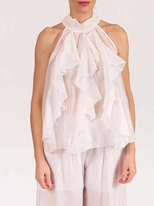 Blouse blanche sans manches avec nœud et volants à l’avant